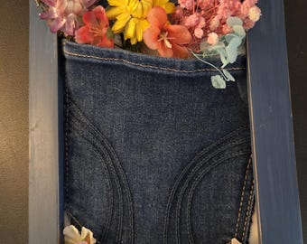 Decorative jean pocket with dried flowers in 5x7 frame. Great for graduates or mom's who love  jeans/flowers. Sit on a bookcase or nighstand