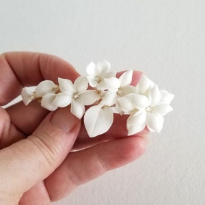 Porcelain flower hair barrette for the bride. Available in silver or gold with white flowers.