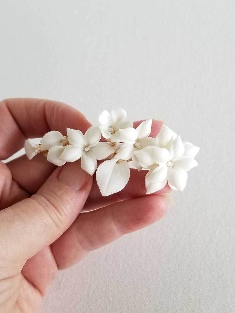 Porcelain flower hair barrette for the bride. Available in silver or gold with white flowers.