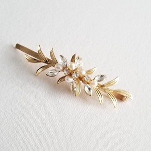 Gold leaf side hair clip for bride. Embellished with freshwater pearls and crystals. Approximately 3 3/8" long by 1" wide.