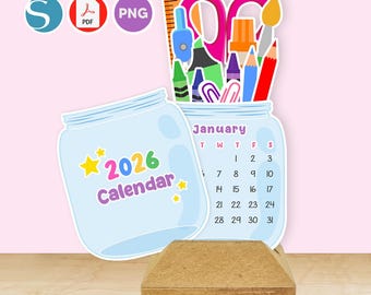 May include: A light blue 2026 calendar in the shape of a jar, with school supplies inside a jar-shaped cutout. The calendar displays the month of January. The calendar is on a wooden stand.