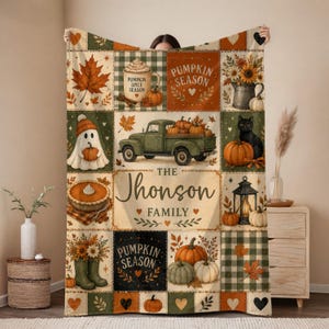 May include: A rectangular throw blanket featuring a patchwork design with autumn themes including pumpkins, a green truck, a ghost, a black cat, and a mug labeled Pumpkin Spice Season. The center displays the text The Jhonson Family in script.