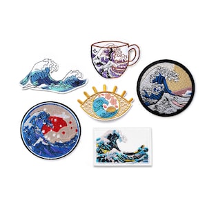 May include: Set of 7 embroidered iron-on patches featuring a Japanese wave design in various colors and styles. The patches include a teacup, an eye, and a wave in a frame.