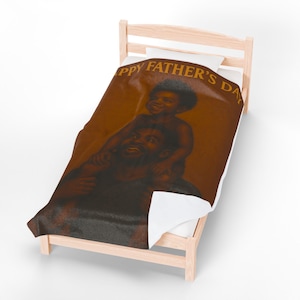 May include: A brown and black twin-size comforter featuring an illustration of a father and son with the text "Happy Father's Day".
