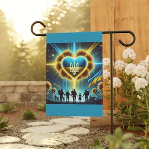 May include: A blue garden flag featuring a heart-shaped sunflower design. The heart is yellow with a blue and yellow Ukrainian flag inside. Silhouettes of people holding hands are at the bottom of the flag.