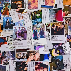 May include: A selection of film posters, including "Little Women," "Lady Bird," and "The Vampire Diaries." The posters are white with images and text, such as film titles and release years. The posters are arranged on a surface.