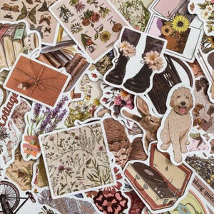 May include: A selection of vintage-style stickers. The stickers depict various images, including flowers, books, boots adorned with flowers, a dog, a rabbit, and a record player. The color scheme incorporates beige, brown, and floral designs.