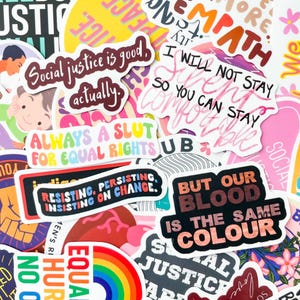 May include: A collection of colorful stickers with various text-based designs. The stickers feature phrases like "Social justice is good, actually," "Always a slut for equal rights," and "But our blood is the same colour." The stickers are diverse in shape and size.