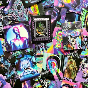 May include: A collection of vibrant, colorful art cards with surreal, futuristic imagery. The cards feature holographic and neon colors, with images of human figures, skulls, and abstract designs. The word "OBSESSED" is printed on one of the cards.