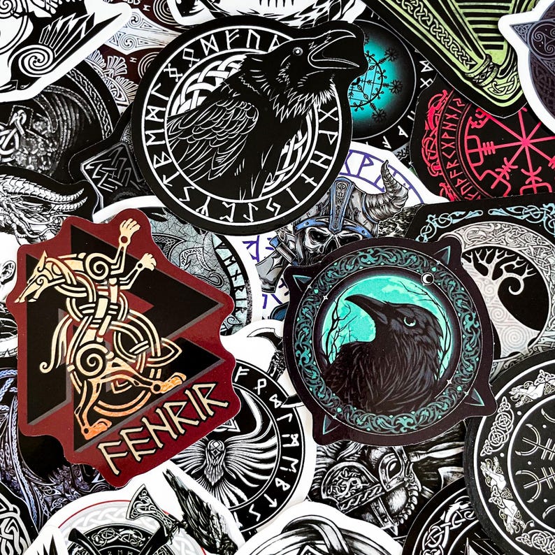 May include: A collection of colorful stickers featuring Norse mythology symbols and creatures. The stickers are round, square, and triangular, with intricate designs and black, white, red, blue, and green colors. The stickers feature images of ravens, wolves, and other mythical creatures, as well as runes and other symbols.