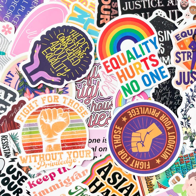 May include: A collection of colorful stickers with various designs and text. The stickers feature phrases like "Equality Hurts No One," "Fight for Those Without Your Privilege," and "There's Nothing Complicated About Equality." The stickers have a variety of colors and fonts.