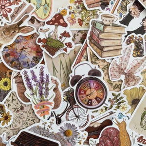May include: A selection of vintage-style stickers with diverse designs. The stickers depict a rabbit, a clock, mushrooms, books, flowers, a bicycle, and a snail. The color scheme is mainly warm, earthy tones with splashes of colour.