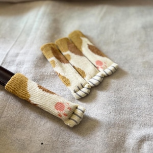 Colecciones de diseños de pata de gato (más largas), protectores antideslizantes y resistentes al desgaste para patas de sillas, fundas tejidas para patas de mesa y fundas para manijas de puertas