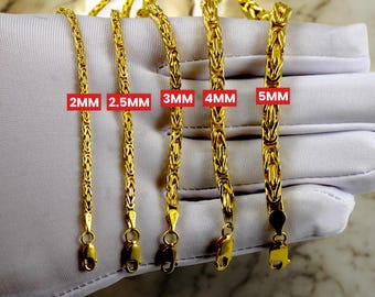 May include: Five gold chains of different widths, labeled 2mm, 2.5mm, 3mm, 4mm, and 5mm. The chains are displayed on a white surface.