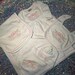 May include: A white baby clothing set featuring a blanket, bib, hat, and gown. Each item is embroidered with a pink bow and the name "Ellie Rae". The edges are trimmed with pink stitching.