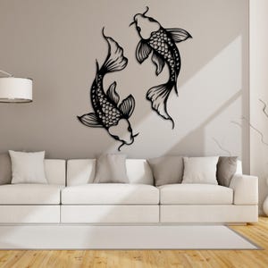 May include: Black metal wall art featuring two stylized koi fish in a circular design. The fish are facing each other and have intricate details.