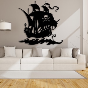May include: Black silhouette of a pirate ship with a skull and crossbones on the sail, set against a white wall. The ship is sailing on waves and is a wall decor piece.