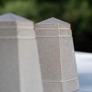 May include: Two light gray, textured concrete obelisk-shaped sculptures with a tapered design and a pointed top. Each piece features horizontal grooved lines near the base and top. The text @STREETCORN.FB is visible in the bottom right corner.