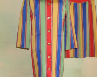 May include: A two-piece set consisting of a long-sleeved, knee-length coat and a matching skirt. Both pieces feature vertical stripes in vibrant shades of blue, yellow, green, and red. The coat has a round neckline and seven gold-toned buttons.