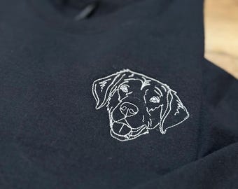 May include: A black t-shirt with a white embroidered image of a dog's head.