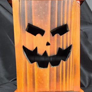 Jack o lantern  in 3 sizes: small 5.5 in tall,medium 9.5 in tall and large 13.5 in tall. Stained or natural, all are treated and sealed