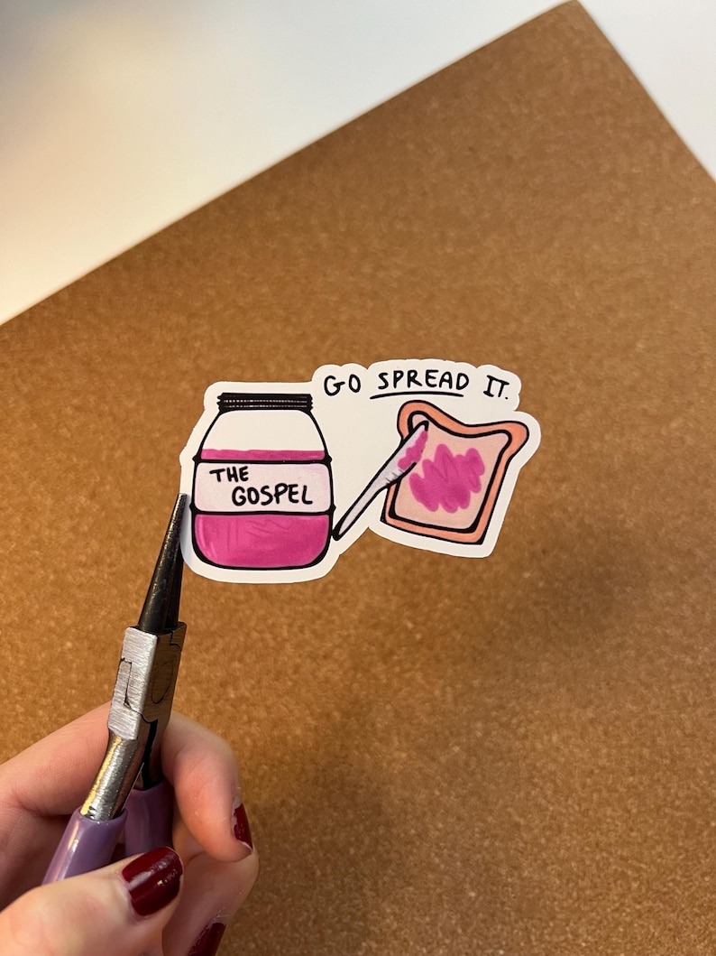 May include: A white ceramic mug with a black handle and the text "But First, Coffee" in a bold, black font. The mug is set against a blurred background, suggesting a cosy setting.