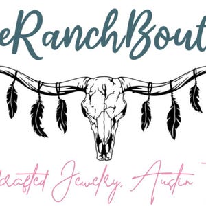 May include: The Blue Ranch Boutique logo displays a steer skull with hanging feathers. The text above reads "Blue Ranch Boutique" in teal script, and below, "Handcrafted Jewelry, Austin TX" in pink script.