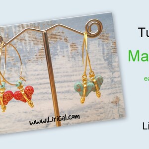 May include: A pair of earrings with a gold heart-shaped charm. One earring has a red heart charm and the other has a turquoise heart charm. The earrings are hanging on a display stand. The text "Tutorial Marsala earrings LiriGal" is visible in the image.