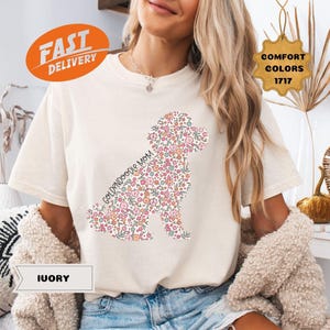 May include: A white t-shirt with a floral goldendoodle silhouette and the text "Goldendoodle Mom".