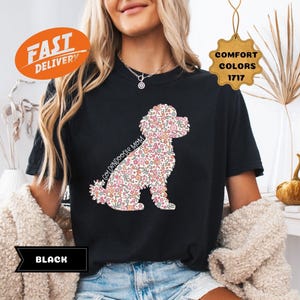 May include: Black t-shirt with a floral doodle of a poodle and the text "Goldendoodle Mom".