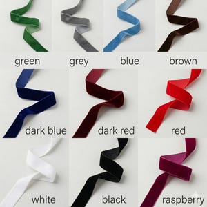 May include: A collection of nine velvet ribbons arranged in a grid, each labeled with its color: green, grey, blue, brown, dark blue, dark red, red, white, black, and raspberry. Each ribbon is displayed in a wavy, flowing shape.