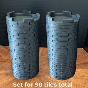 May include: Two gray, cylindrical castle tower models with a brick pattern. Each tower has a crenelated top. The set is 10.7" x 5" (272mm x 127mm) and is for 90 tiles total.