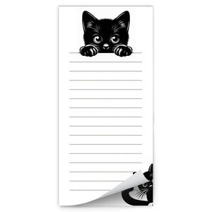 May include: A black and white notepad with a black cat peeking over the top. The notepad has lined paper and a curled corner.