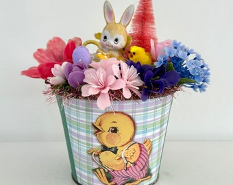 Vintage Easter assemblage arrangement ceramic rabbit bottlebrush tree plastic flowers in retro metal bucket with chick