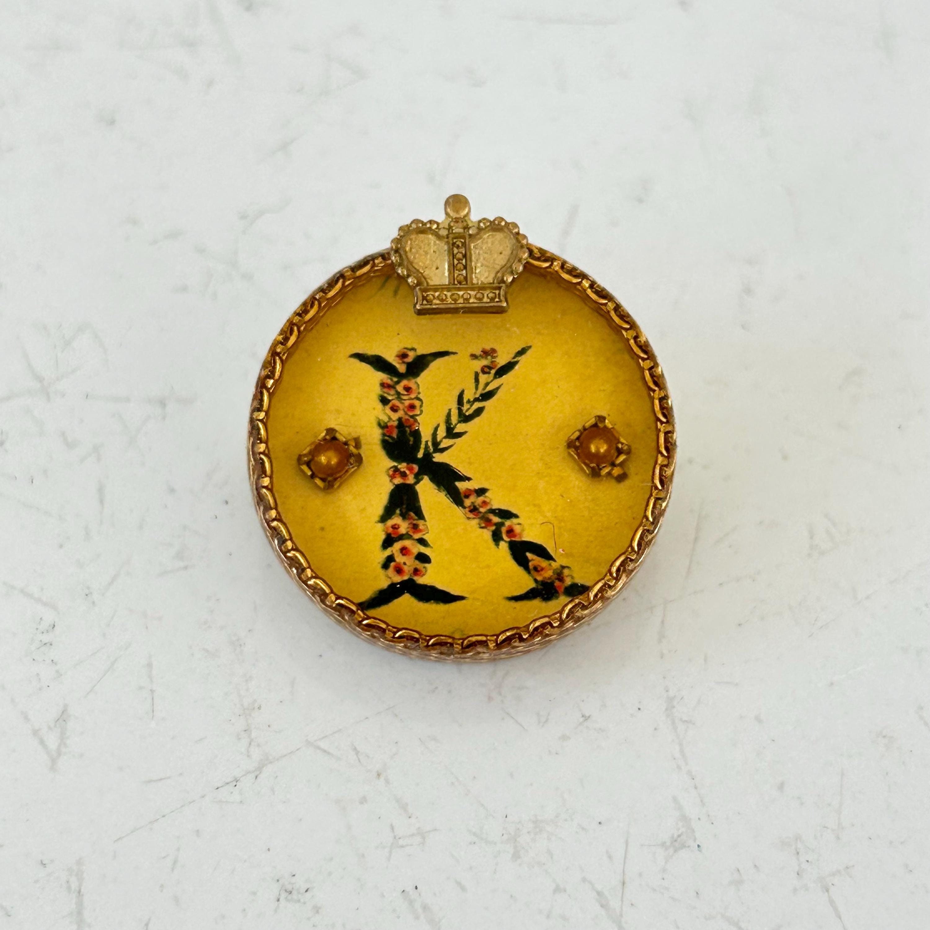 Vintage Maximal Art round pin brooch of initial K and crown on antiqued background