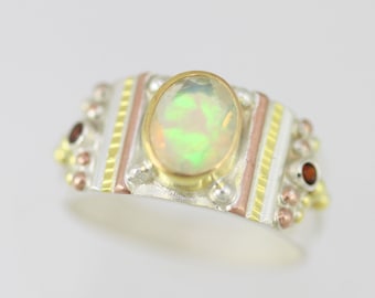 Oval Ethiopian Opal Totem Ring with Garnet in 14ky gold, silver, and copper