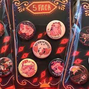 May include: Three packs of pin-back buttons, each containing five pins. The pins feature various cartoon characters and phrases like "The Bodyguards," "Still Fun Sized!," and "The Key to the Hotel." The pins are primarily red, black, and pink.