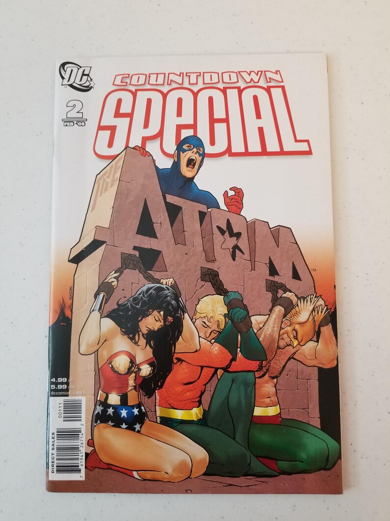Może przedstawiać: Okładka komiksu "Countdown Special" nr 2, z Atomem, Wonder Woman i Aquamanem. Okładka przedstawia postacie w dramatycznej scenie z odważnymi kolorami i dynamicznymi pozami. Widoczne jest logo DC Comics.