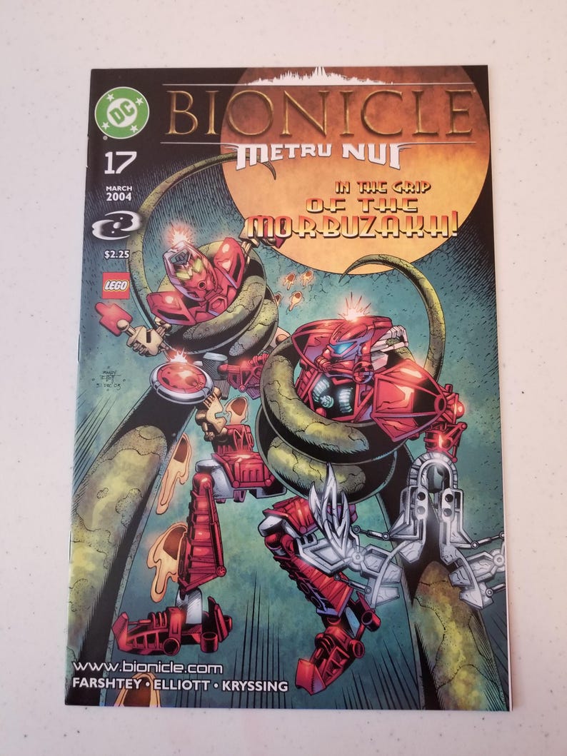 Może przedstawiać: Komiks Bionicle, numer 17, przedstawiający czerwone i srebrne robotyczne postacie walczące z zielonym stworzeniem przypominającym węża. Okładka zawiera tekst "Metru Nui" i "In the Grip of the Morbuzahk!" z logo DC Comics i LEGO.