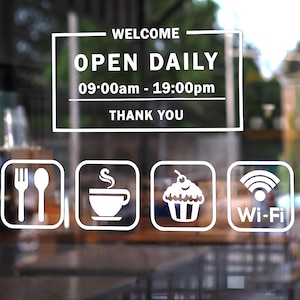 May include: White sign on a glass door with the words "WELCOME OPEN DAILY" and hours of operation. Below are icons for a fork and spoon, coffee cup, cupcake, and Wi-Fi.