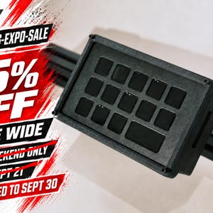 May include: A black rectangular button box controller with a grid of fifteen square buttons mounted on a black rail. The image features red and white graphic text that reads SIM-RACING-EXPO-SALE 15% OFF STORE WIDE THIS WEEKEND ONLY ENDS SEPT 21 EXTENDED TO SEPT 30.