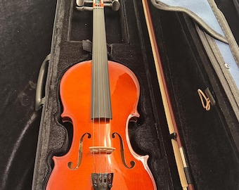 May include: A reddish-brown violin with a black fingerboard and a bow, resting inside a black case with a blue interior. The violin has a glossy finish and is designed with f-holes.