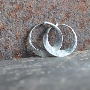 May include: A set of three ceramic mugs with a speckled, matte finish. The mugs are in shades of cream, light gray, and dark gray. Each mug has a simple, minimalist design, perfect for coffee or tea.