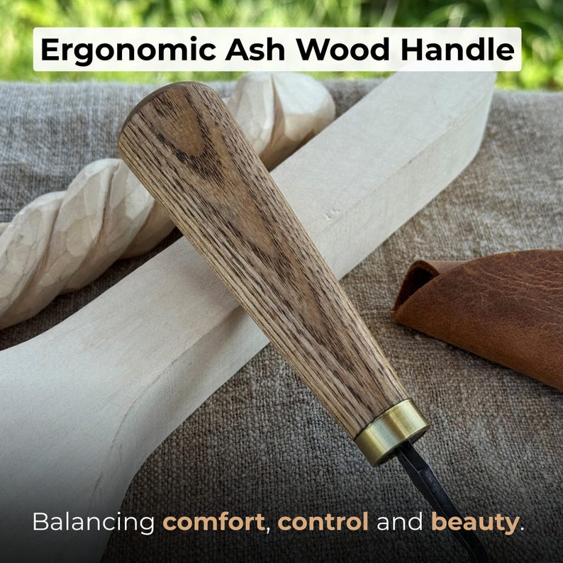 May include: Close-up of a woodworking tool with an ergonomic ash wood handle. The handle is a light brown color with a brass ferrule. The text reads "Ergonomic Ash Wood Handle" and "Balancing comfort, control and beauty."