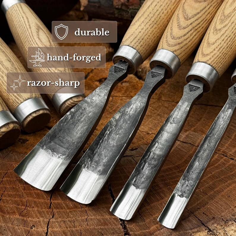 May include: A set of wood carving chisels with light-coloured wooden handles and dark, textured metal blades. The image includes text labels reading durable, hand-forged, and razor-sharp. The tools feature metal ferrules connecting the blades to handles.