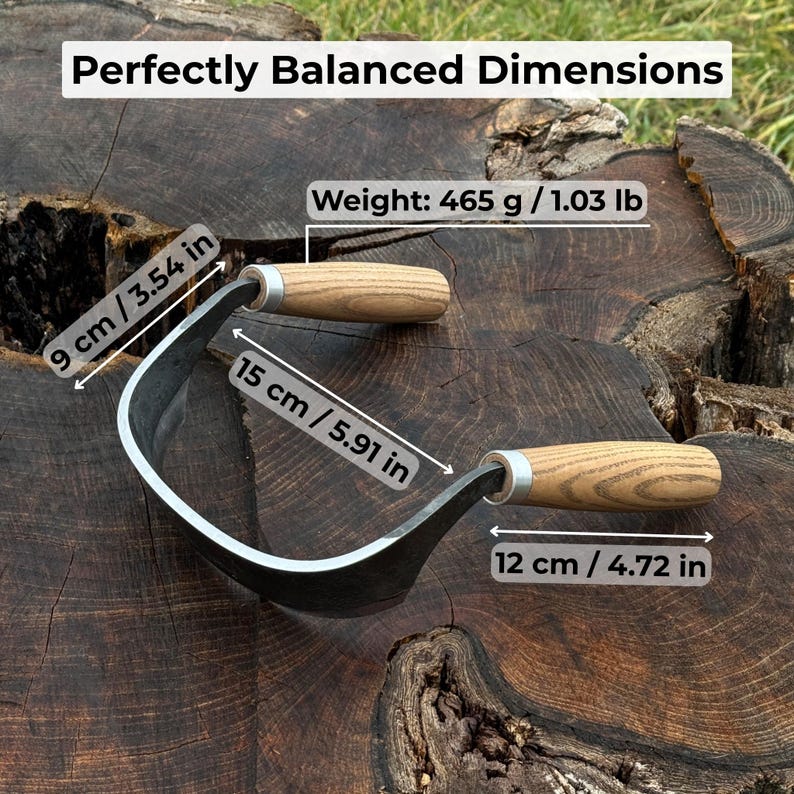 May include: A curved, black metal garden tool with wooden handles. The tool is 15 cm (5.91 in) long, 9 cm (3.54 in) wide, and the handle is 12 cm (4.72 in) long. The weight is 1.03 lb (465 g). The text "Perfectly Balanced Dimensions" is at the top.