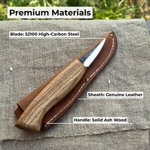 Wood carving knife on workbench with labeled materials, highlighting forged carbon steel blade, ash handle, and durable handmade build.