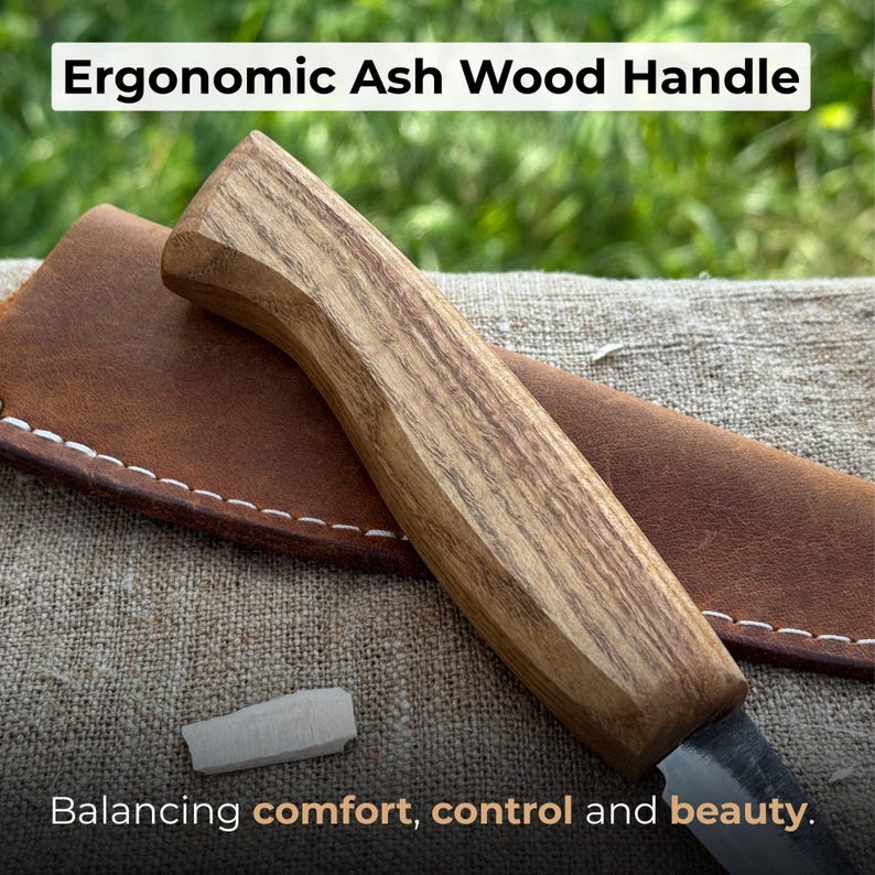 Ash handle of wood carving knife close-up, highlighting ergonomic handmade shape, smooth finish, and natural wood grain.