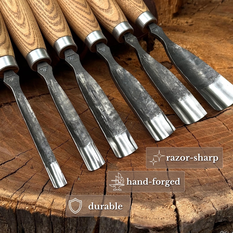 May include: A set of six wood carving gouges with light-colored wooden handles and dark, textured metal blades. Each blade features a stamped logo and a curved edge. Text overlays on the image include the phrases razor-sharp, hand-forged, and durable.
