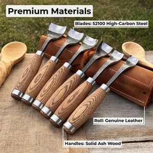 May include: A set of wood carving tools with ash wood handles and high-carbon steel blades. The blades are silver, and the handles are a light brown color. The tools are displayed on a brown leather roll. The text "Premium Materials" is at the top.
